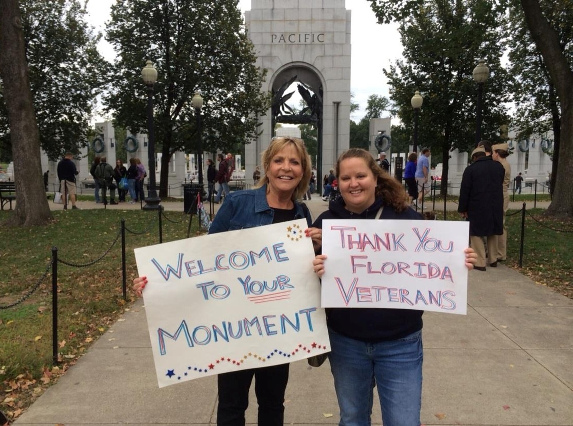 (Left) Debbie Gasaway, and Heidi Hunt, 45th Space Wing Public Affairs specialist, greet veterans at the World War II Memorial, Washington, D.C., in conjunction with members of Andrews Air Force Base, Md., Oct. 19, 2013. Military and civilian volunteers from the local area attend each ceremony in support of the Honor Flight Program. (Courtesy photo)