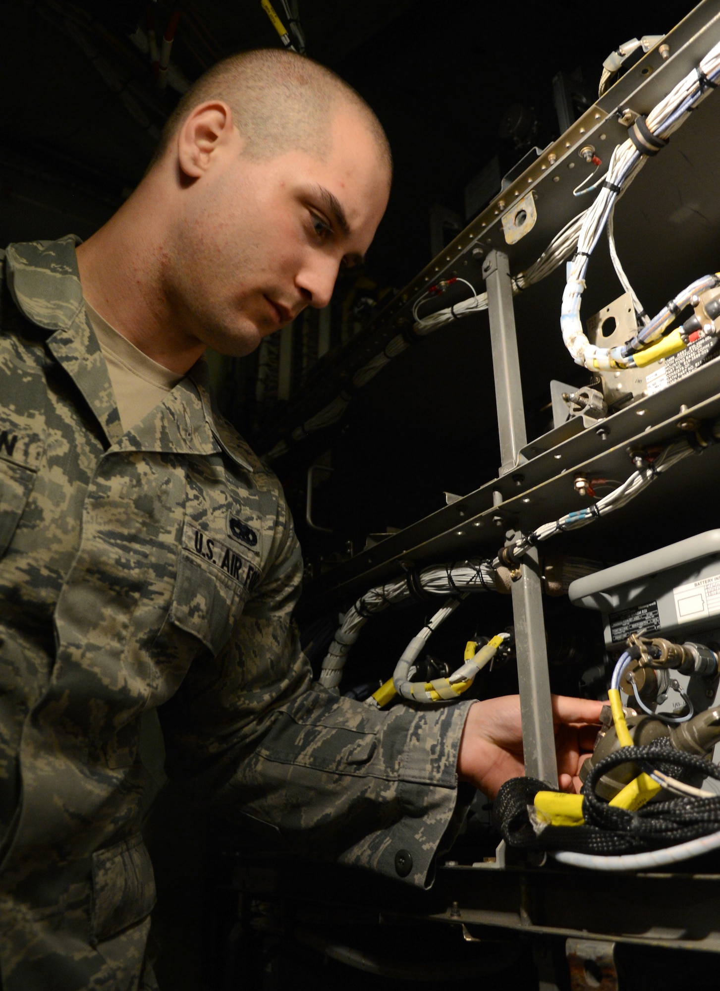 U.S. Air Force Senior Airman Jarred McGlothin, 100th Aircraft Maintenance Squadron instruments and flight controls systems journeyman from Elkton, Md., inspects avionics equipment onboard a KC-135 Stratotanker April 17, 2014, on RAF Mildenhall, England. The avionics equipment includes vital computer components such as the flight recorder and autopilot systems. (U.S. Air Force photo by Airman 1st Class Dillon Johnston/Released)