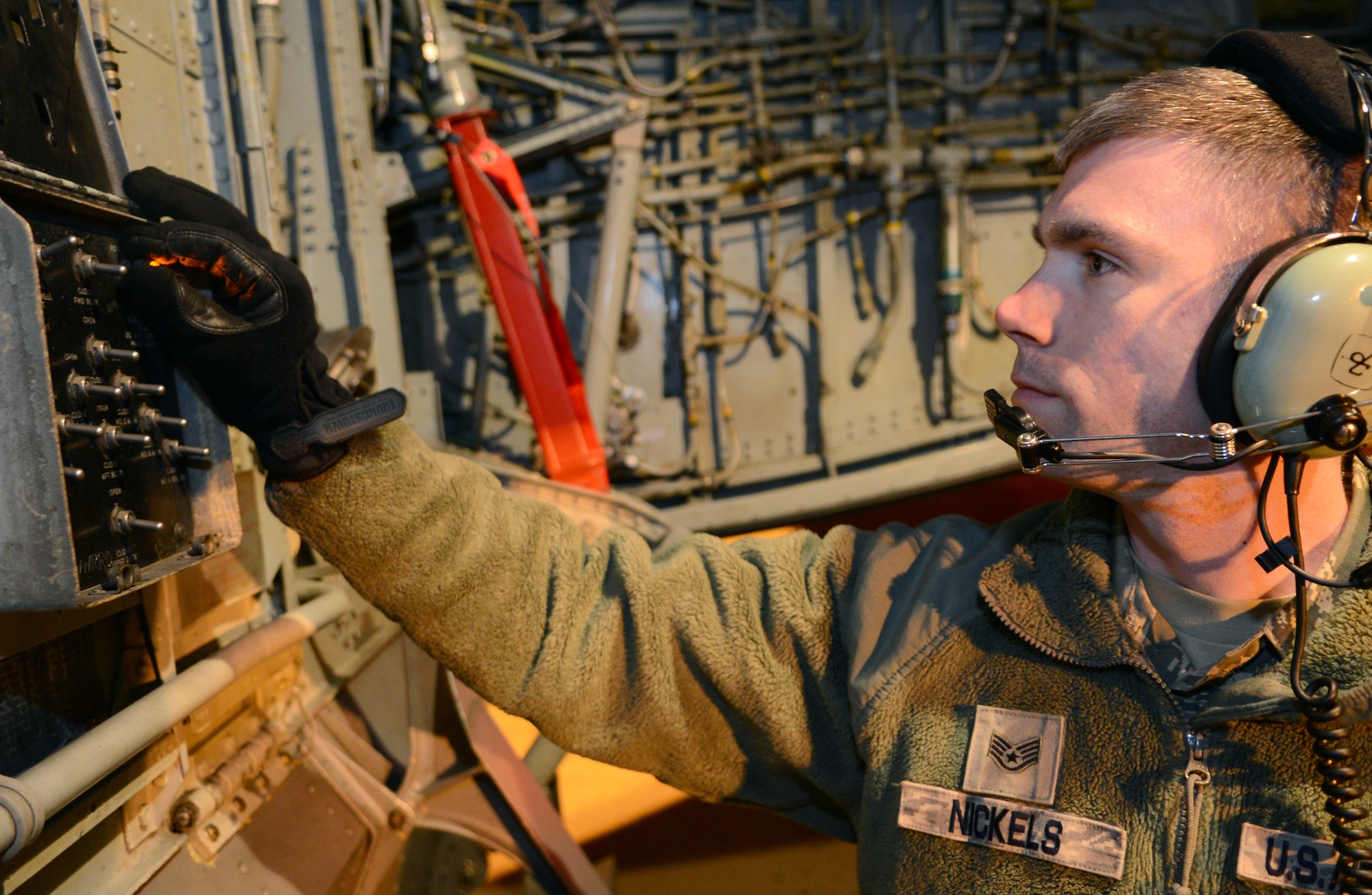 U.S. Air Force Staff Sgt. Kyle Nickels, 100th Aircraft Maintenance Squadron crew chief from Troy, Ohio, prepares a KC-135 Stratotanker to take on fuel April 17, 2014, on RAF Mildenhall, England. Prior to refueling, a crew chief must ensure that a switchboard located on the undercarriage of the plane is correctly configured to route fuel to different tanks in the aircraft. (U.S. Air Force photo by Airman 1st Class Dillon Johnston/Released)  