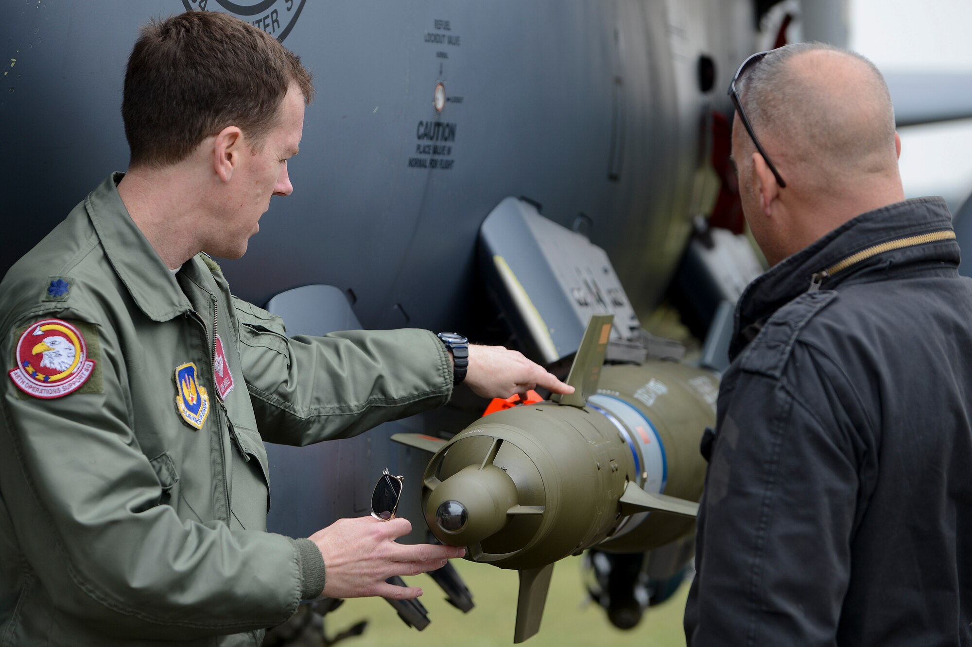 Lt. Col. Christopher Russell, 48th Operations Support Squadron commander, explains the munitions on an F-15E Strike Eagle to Mr. Ed Kerr, 56th Rescue Squadron honorary commander select, during his visit to Royal Air Force Lakenheath, England, April 17, 2014. The honorary commander visited as part of an outreach to better understand the base’s mission and roles.  (U.S. Air Force photo by Airman 1st Class Trevor T. McBride/Released)