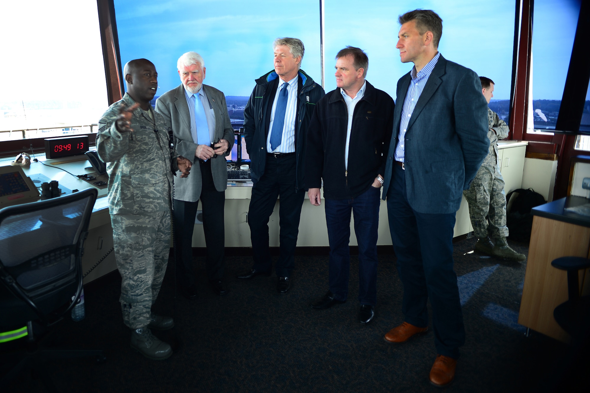 Master Sgt. Jessie Green, 48th Operations Support Squadron aircraft control tower chief controller, explains responsibilities of the control tower to honorary commanders during their visit to Royal Air Force Lakenheath, England, April 17, 2014. The honorary commanders visited as part of an outreach to better understand the base’s mission and roles.  (U.S. Air Force photo by Staff Sgt. Emerson Nuñez/Released)