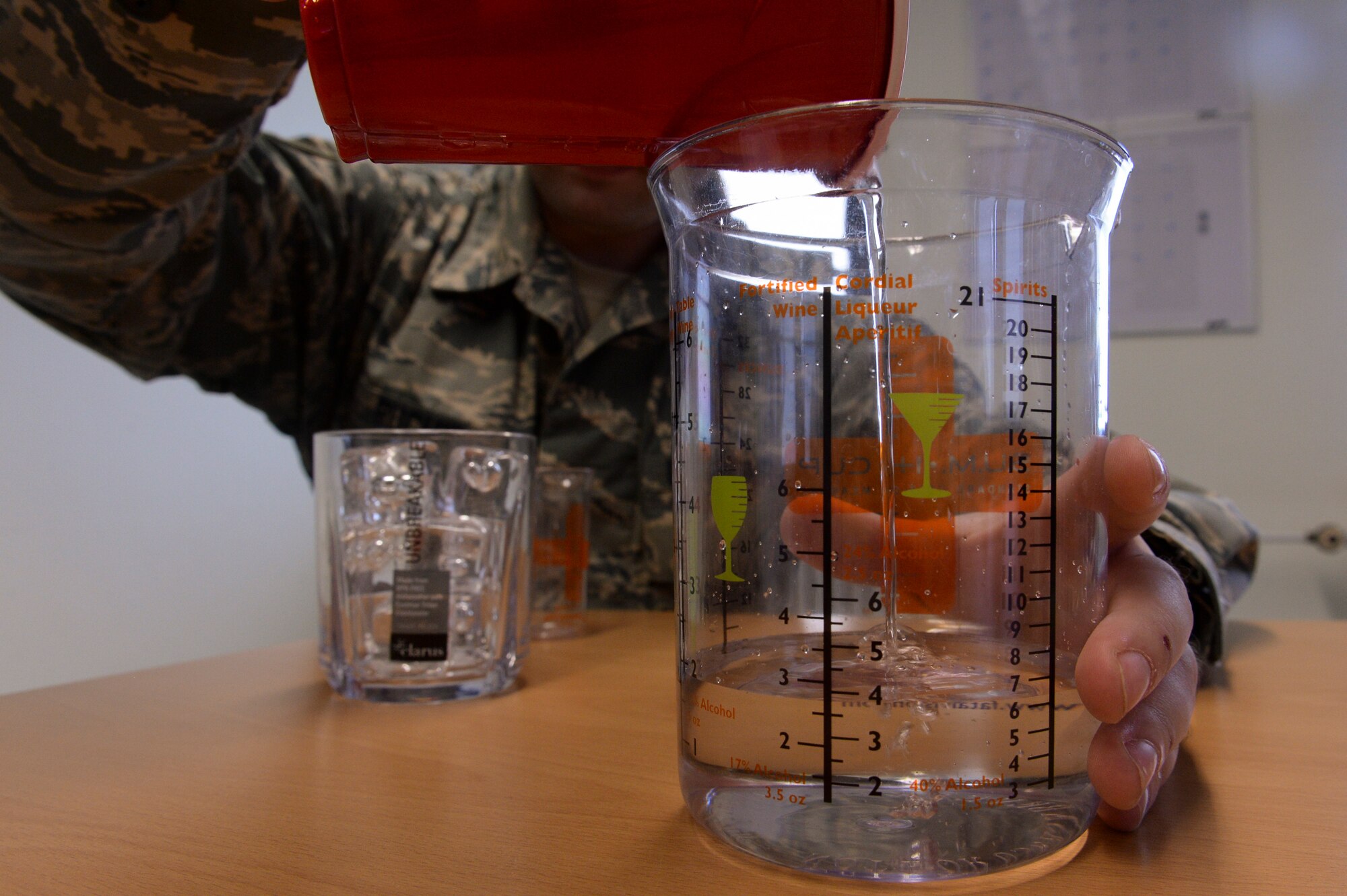 U.S. Air Force Staff Sgt. Matthew Ruchie, a 52nd Medical Operations Squadron mental health craftsman, from St. Paul, Minn., pours water into a standard unit of measurement cup also referred to as a “SUM–it-up cup,” April 17, 2014, at Spangdahlem Air Base, Germany. A visual tool, the cup measures how much alcohol is used for the various types of drink sizes. (U.S. U.S. Air Force photo by Senior Airman Rusty Frank/Released)