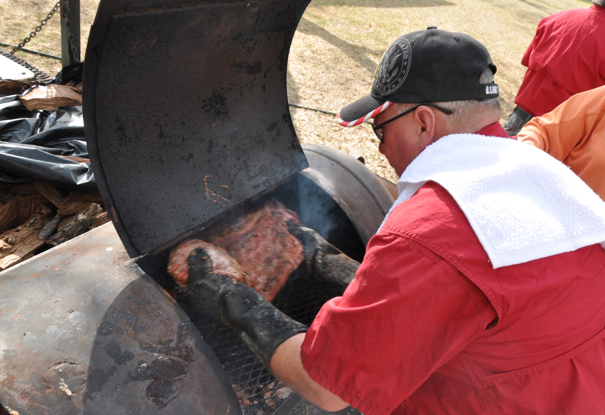 GOODFELLOW AIR FORCE BASE, Texas – John M. Farris, Goodfellow Recreation Camp manager, moves a brisket during a brisket cooking class at the rec. camp here April 19. Farris taught participants how to season, smoke and properly cut a brisket. (U.S. Air Force photo/ Senior Airman Joshua Edwards)