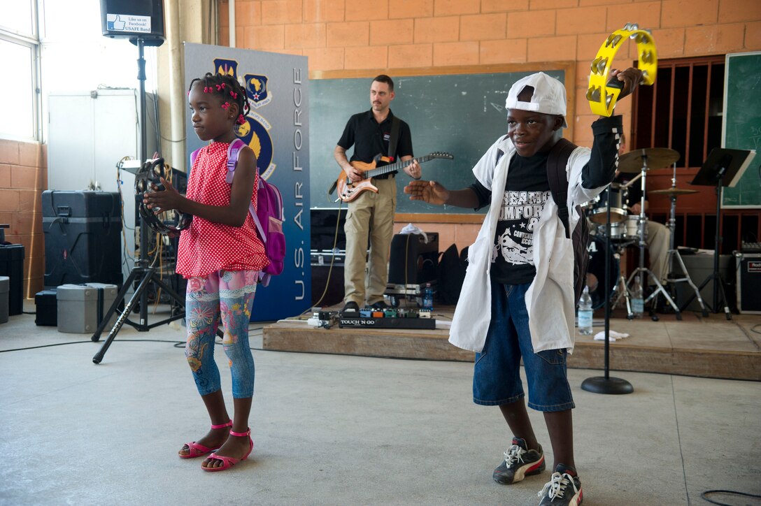 Children from the Dom Bosco School in Luanda, Angola, dance in front of the stage as the U.S. Air Forces in Europe Band ensemble Touch n' Go performs a song March 26, 2014. The band is in Angola as part of African Partnership Flight Angola 2014, which is an event providing a collaborative learning environment for the Angolan, U.S. and Zambian air forces. (U.S. Air Force photo/Tech. Sgt. Benjamin Wilson)(Released)