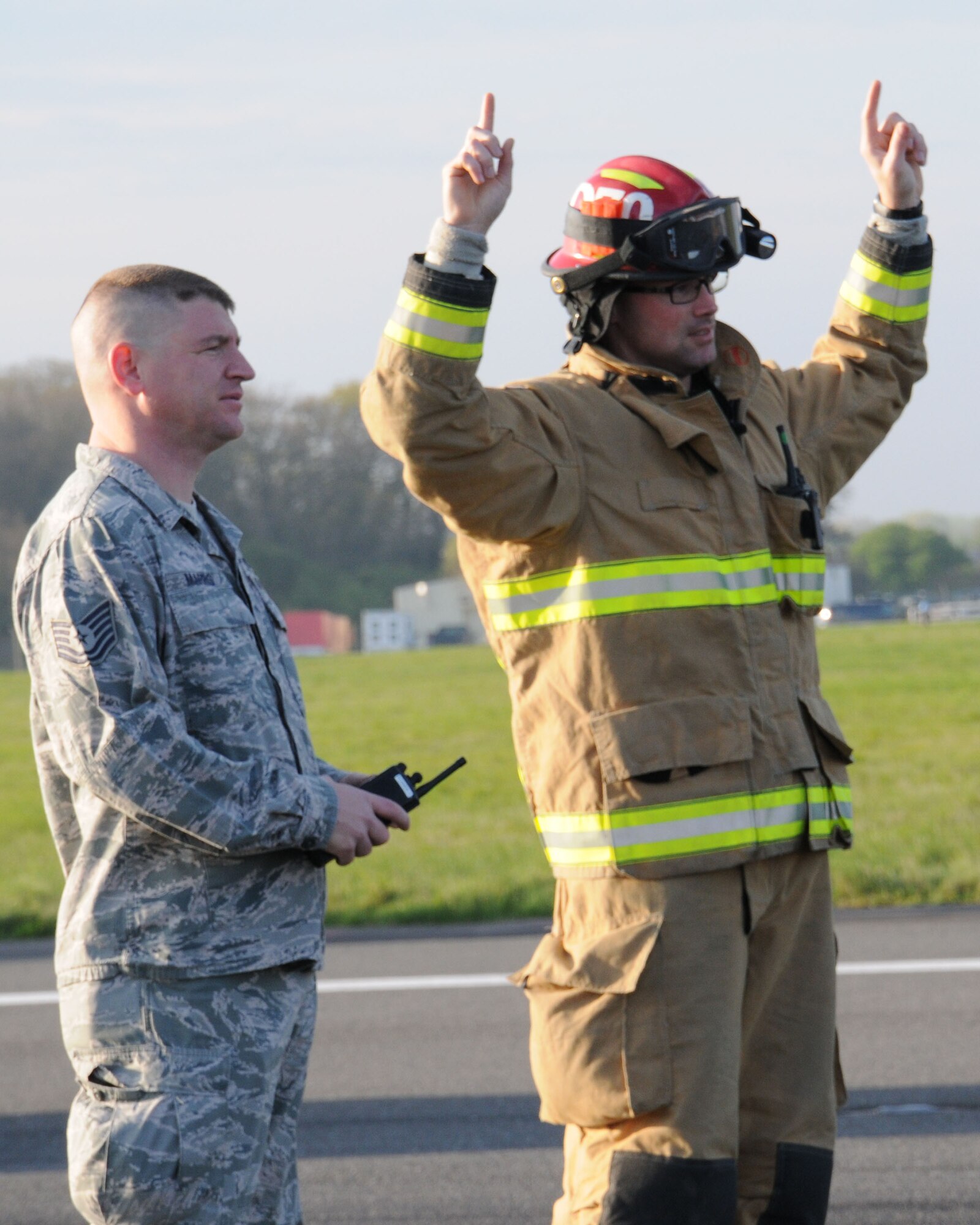 U.S. Air Force Tech. Sgt. Christopher Marrs, left, 100th Civil Engineer Squadron NCO in charge of power production from Eugene, Ore., and U.S. Air Force Staff Sgt. Kyle Dulin, 100th CES firefighter from Redondo Beach, Calif., lead a barrier testing operation April 17, 2014, on RAF Mildenhall, England. The Airmen conducted rewind operations and gave signals to personnel in shacks. There are two shacks housing the machines that reel in the barrier, one on each side of the runway. They use a two-person concept to ensure safety. (U.S. Air Force photo by Gina Randall/Released)