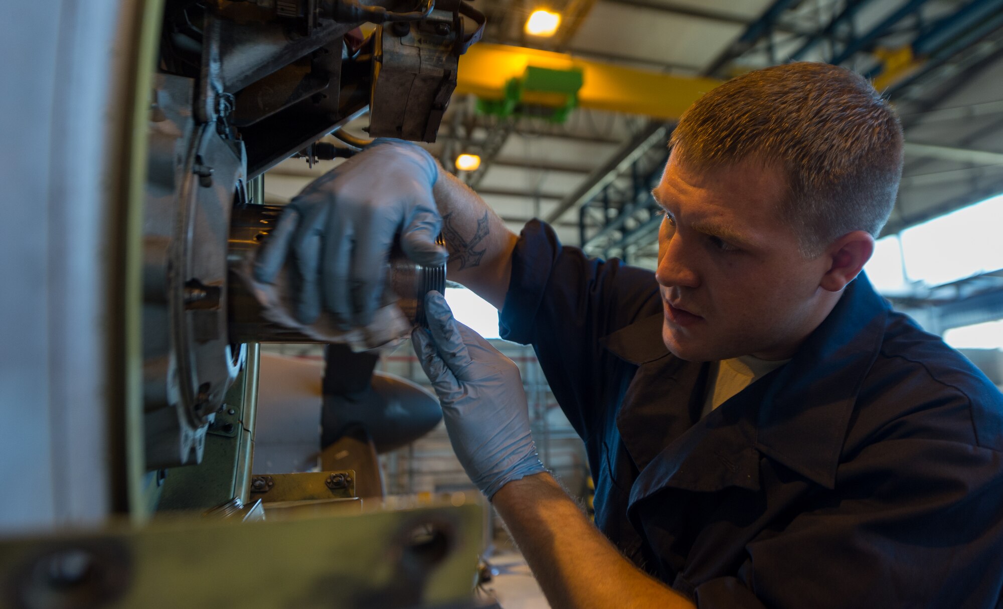 Senior Airman Austin Payne, 86th Aircraft Maintenance Squadron aerospace propulsion technician, cleans and applies lubrication during a repair on Ramstein Air Base, Germany, April 21, 2014. Payne, a Champaign, Ill. native, was part of an 86th AMXS team that replaced a prop shaft adapter on a C-130J Super Hercules. (U.S. Air Force photo/Airman 1st Class Jordan Castelan)