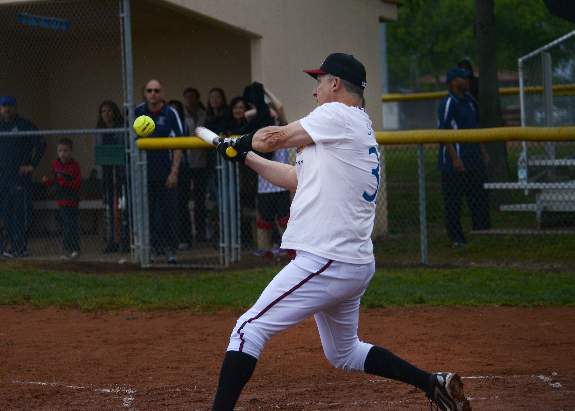 Col. Brent Vosseller, 31st Fighter Wing vice commander, swings at a softball during the Chiefs and Eagles game at the “Baseball Blast-off” event, April 19, 2014, at Aviano Air Base, Italy.  The Chiefs and Eagles game is an annual tradition for chiefs and commanders to come together and play against each other for bragging rights. The Chiefs ran to victory with the final score of 20-14. (U.S. Air Force photo/Airman 1st Class Deana Heitzman)