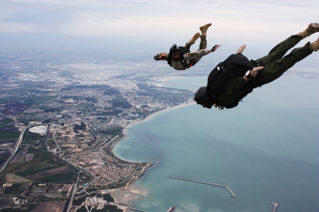 U.S. Navy Petty Officer 1st Class John Delong tracks with another parachutist during free fall training on Naval Station Rota Spain in Rota, Spain, April 14, 2014. Delong is assigned to Explosive Ordnance Disposal Mobile Unit 8.
