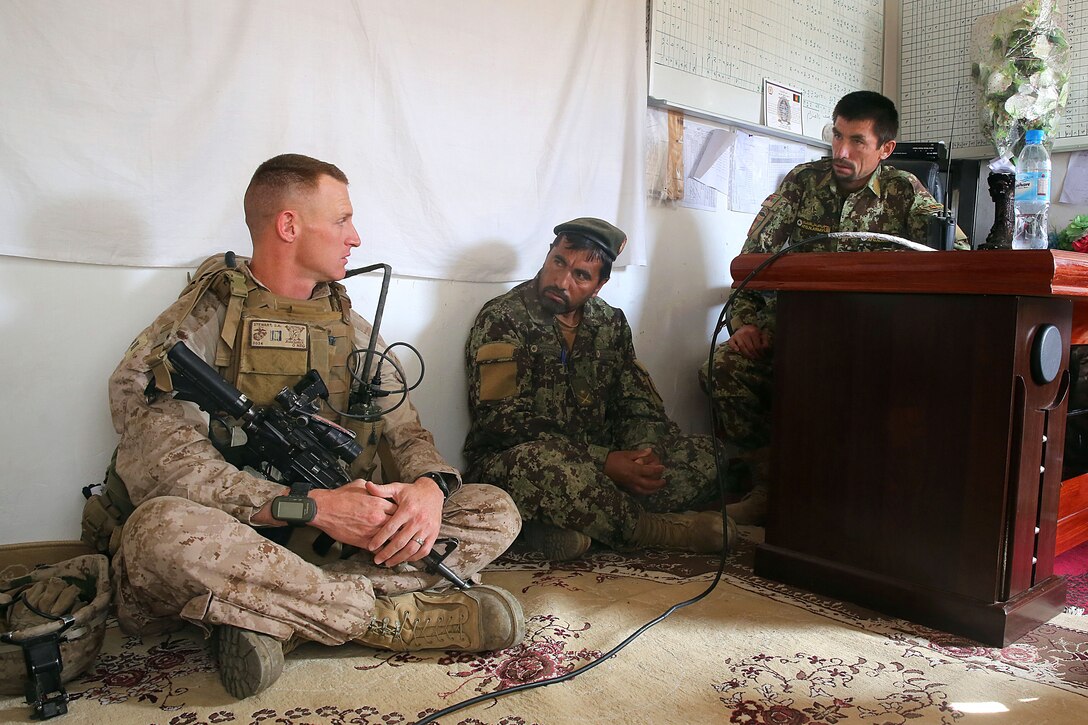 U.S. Marine Corps Captain Scott Stewart, left, speaks with senior Afghan army officers during a mission in Helmand province, Afghanistan, April 17, 2014. Stewart, a commander, is assigned to Weapons Company, 1st Battalion, 7th Marine Regiment.