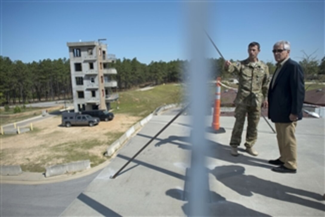 Defense Secretary Chuck Hagel watches a live-fire demonstration behind a blast screen while touring a special operations command on Fort Bragg, N.C., April 23, 2014. Hagel traveled to Fort Bragg to visit military members, receive briefings, and view unit demonstrations and capabilities. The secretary will continue his three-day trip to Mexico and Guatemala to meet with defense counterparts.