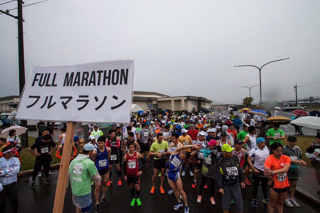 Americans and Japanese participants stretch before beginning the full marathon portion of the 2014 Kintai Marathon, which took place aboard Marine Corps Air Station Iwakuni, Japan, April 13. The marathon is one of the few annual events that give Japanese citizens an opportunity to come aboard station. Approximately 800 people signed up for the full marathon, half marathon and five-kilometer walk.