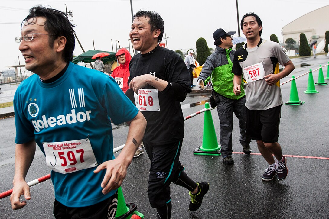 Japanese participants of the 2014 Kintai Marathon, which took place aboard Marine Corps Air Station Iwakuni, Japan, cross the finish line after running a half-marathon, April 13. The Kintai Marathon is one of the few annual events that give Japanese citizens an opportunity to come aboard station. Approximately 800 people signed up for the full marathon, half marathon and five-kilometer walk.
