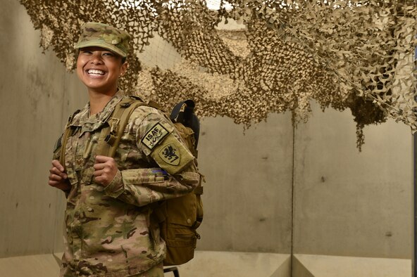 Staff Sgt. Sheena Raya Amaya smiles before a pre-convoy briefing March 14, 2014 at Kandahar Air Field, Afghanistan. Amaya is the primary combat medic on mission convoys and provides clinic-level care for soldiers at Kandahar Air Field. (U.S. Air Force photo/Staff Sgt. Vernon Young Jr.)