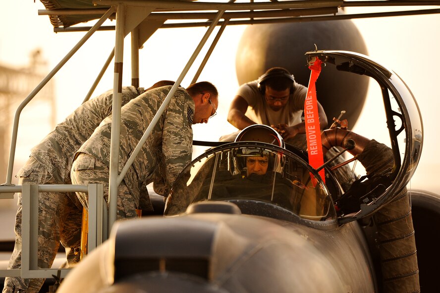 Airmen with the 99th Expeditionary Reconnaissance Squadron integrate Lt. Col. Jeff Klosky into his U-2, April 20, 2014, at a flightline in Southwest Asia. U-2 pilots need additional help boarding their aircraft because of their full pressure suits. (U.S. Air Force photo/Tech. Sgt. Russ Scalf)