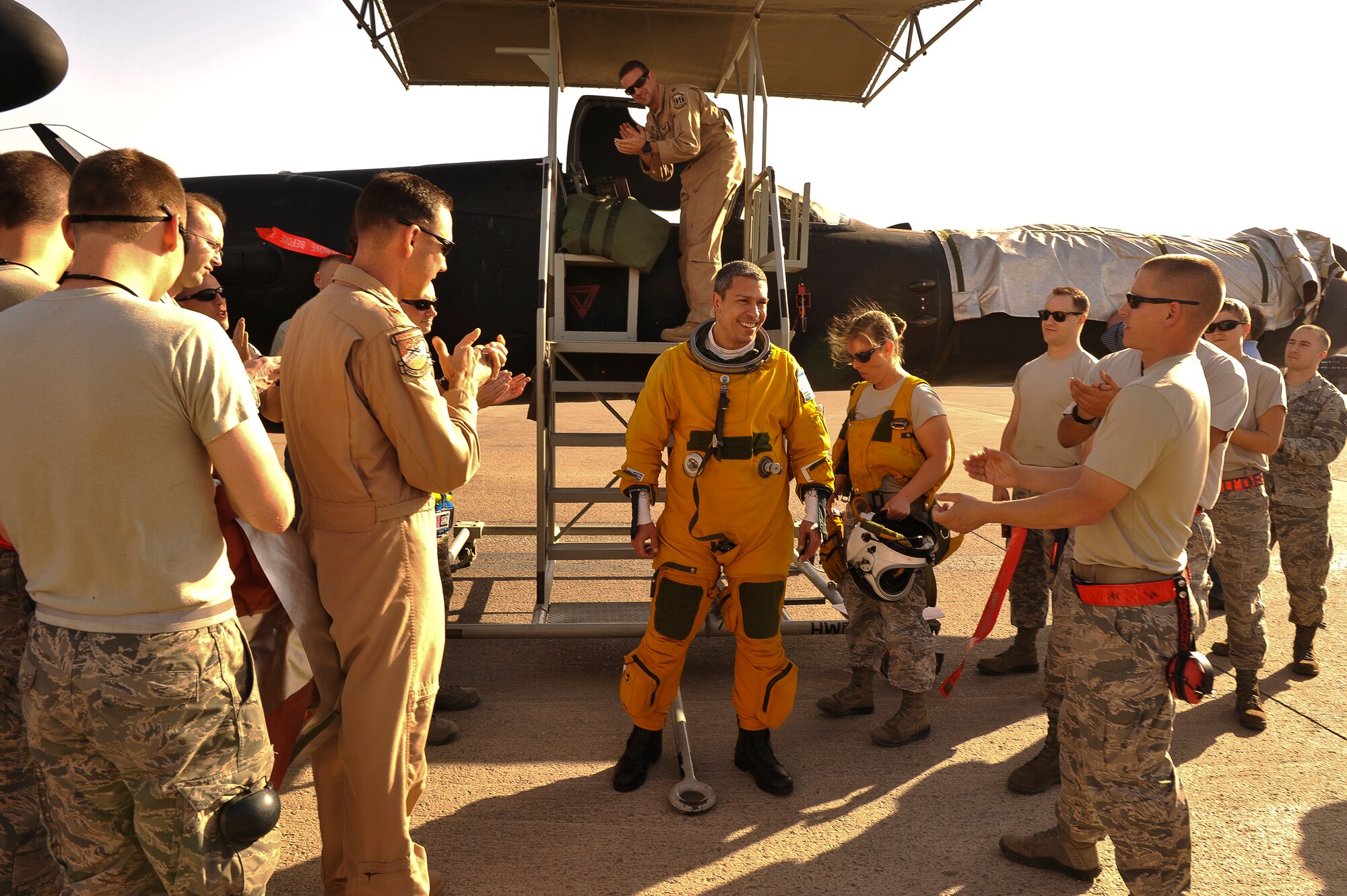 Lt. Col. Jeff Klosky is congratulated by members of the 380th Expeditionary Aircraft Maintenance Squadron and the 99th Expeditionary Reconnaissance Squadron following his flight April 20, 2014, at a flightline in Southwest Asia. The flight marked Klosky’s 2,500th hour of flight in the U-2. (U.S. Air Force photo/Tech. Sgt. Russ Scalf)