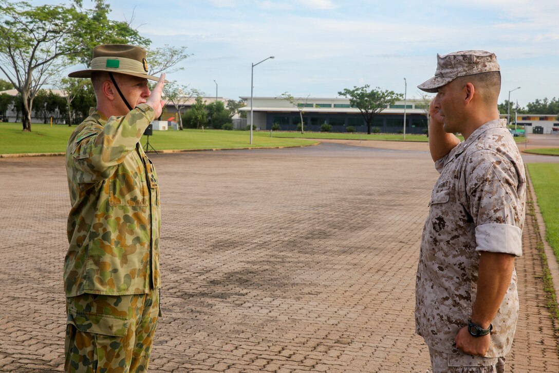 Lt. Col. Keven Matthews, commanding officer of Marine Rotational Force – Darwin, and Brig. Gen. John Frewen, 1st Brigade commanding general and senior Australian Defence Force officer for Robertson Barracks, salute one another after Frewen addresses the Marines of MRF-D about expectations for the rotation, April 11. Frewen said the rotation is a tangible sign of the strength between Australia and the United States.