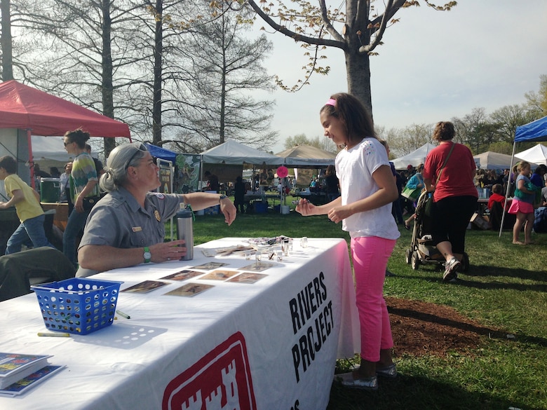 Angie Smith, St. Louis District park ranger talks with visitor about macroinvertebrates at the 2013 Forest Park Earth Day celebration in St. Louis, Mo.