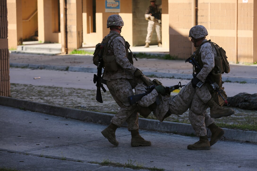 Marines with 2nd Battalion, 6th Marine Regiment, evacuate a simulated casualty during a demonstration of Military Operations in Urban Terrain during World War II Day aboard Marine Corps Base Camp Lejeune, N.C., April 24, 2014. “I feel honored to be a part of this demonstration and show them how we do what they used to do,” said Lance Cpl. Cody Barbour, a rifleman with 2nd Battalion, 6th Marine Regiment.