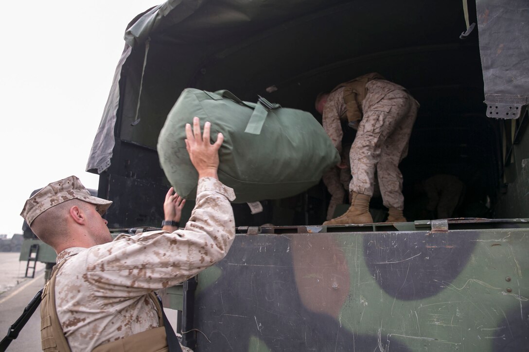 U.S. Marines load luggage into the back of a 7-ton truck April 16 during Korean Marine Exchange Program 14-6 in Pohang, Republic of Korea. KMEP 14-6 is one in a series of regularly-scheduled combined, small-unit, tactical training exercises. The Marines are with 9th Engineer Support Battalion, 3rd Marine Logistics Group