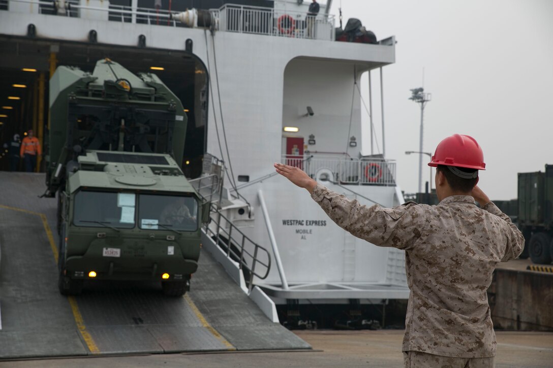 U.S. Marine Pfc. David A. Jacome directs a logistics support vehicle offloading from a high-speed vessel April 16 during Korean Marine Exchange Program 14-6 in Pohang, Republic of Korea. During the exercise, ROK and U.S. Marines will conduct field training exercises designed to enhance small-unit tactics. Jacome is from Miami, Fla., and a landing support specialist with Combat Logistics Battalion 4, 3rd Marine Logistics Group.