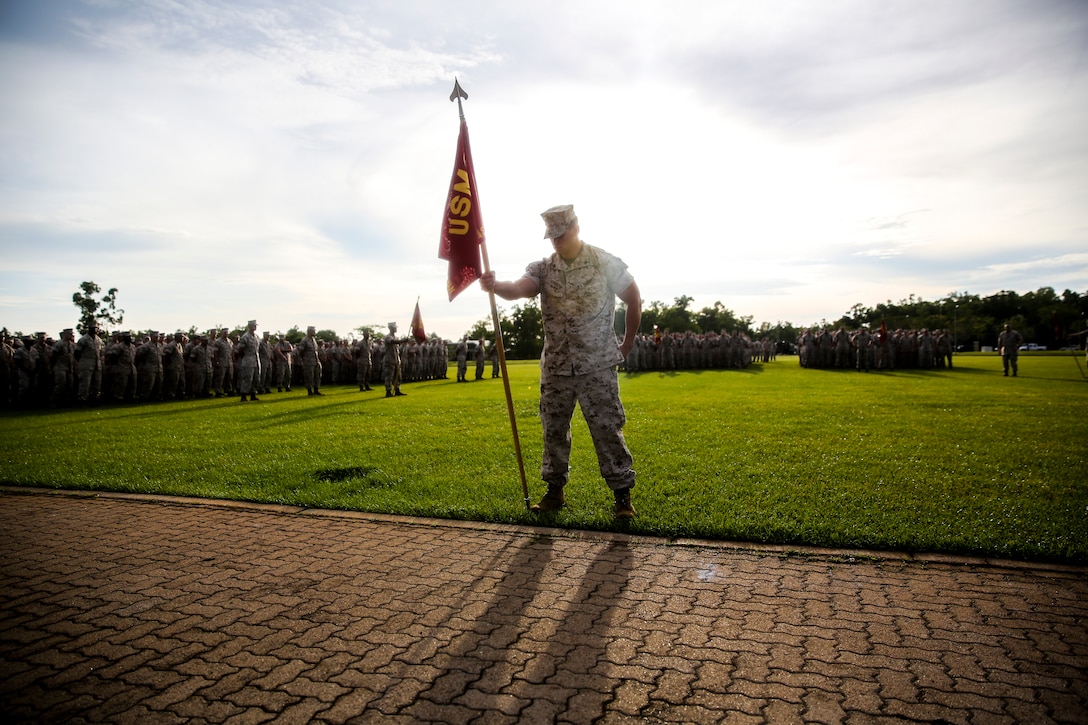 Marines with Marine Rotational Force – Darwin form up around Brig. Gen. John Frewen, 1st Brigade commanding general and senior Australian Defence Force officer for Robertson Barracks, to listen to him speak about expectations with the rotation, April 11, 2014. Frewen said the rotation is a tangible sign of the strength between Australia and the United States.