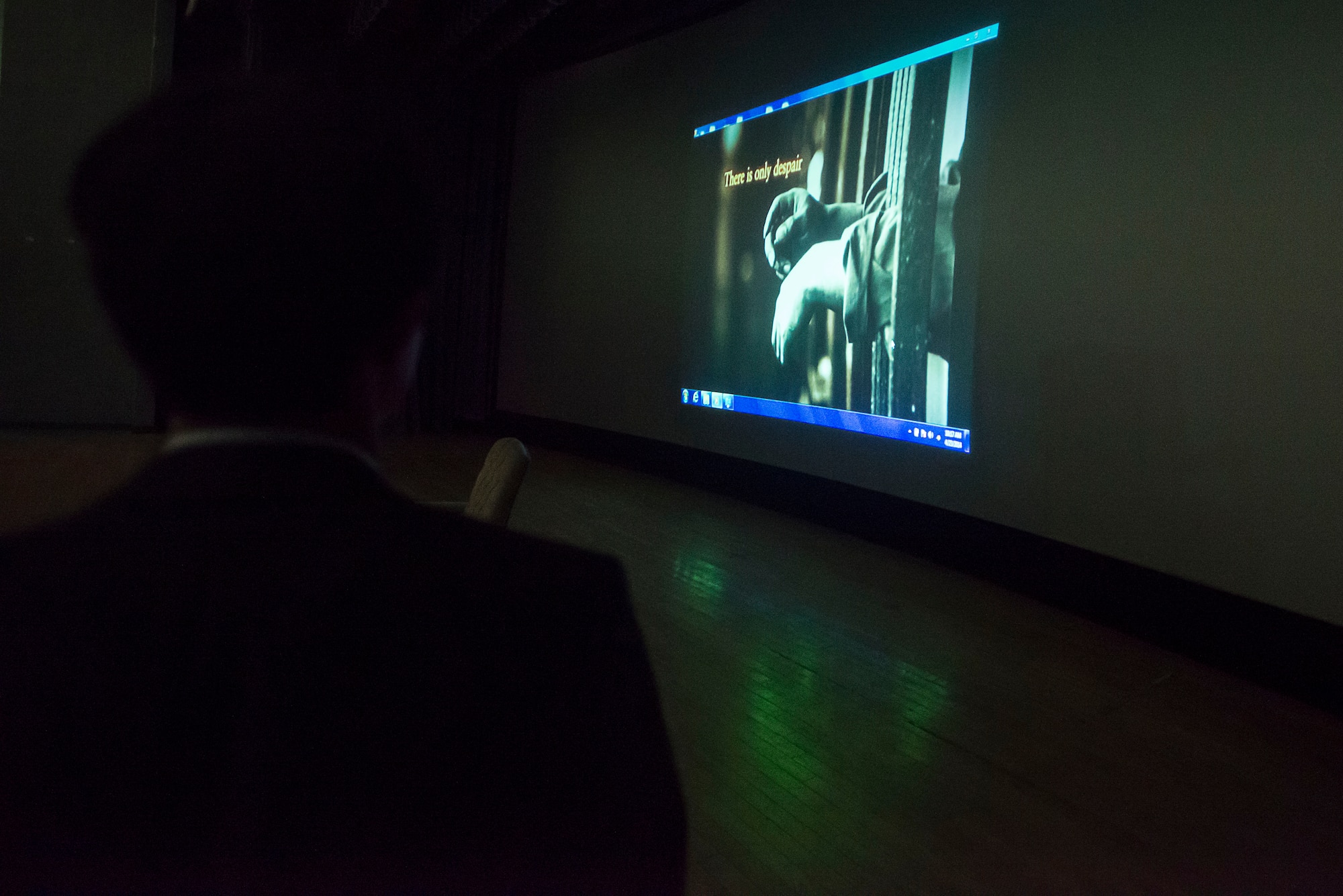 Shin Dong-hyuk, escapee of a North Korean interment camp, watches a video about prison camps during a presentation April 23, 2014, at Osan Air Base, Republic of Korea. Shin's story is featured in the book Escape From Camp 14 by Blaine Harden.