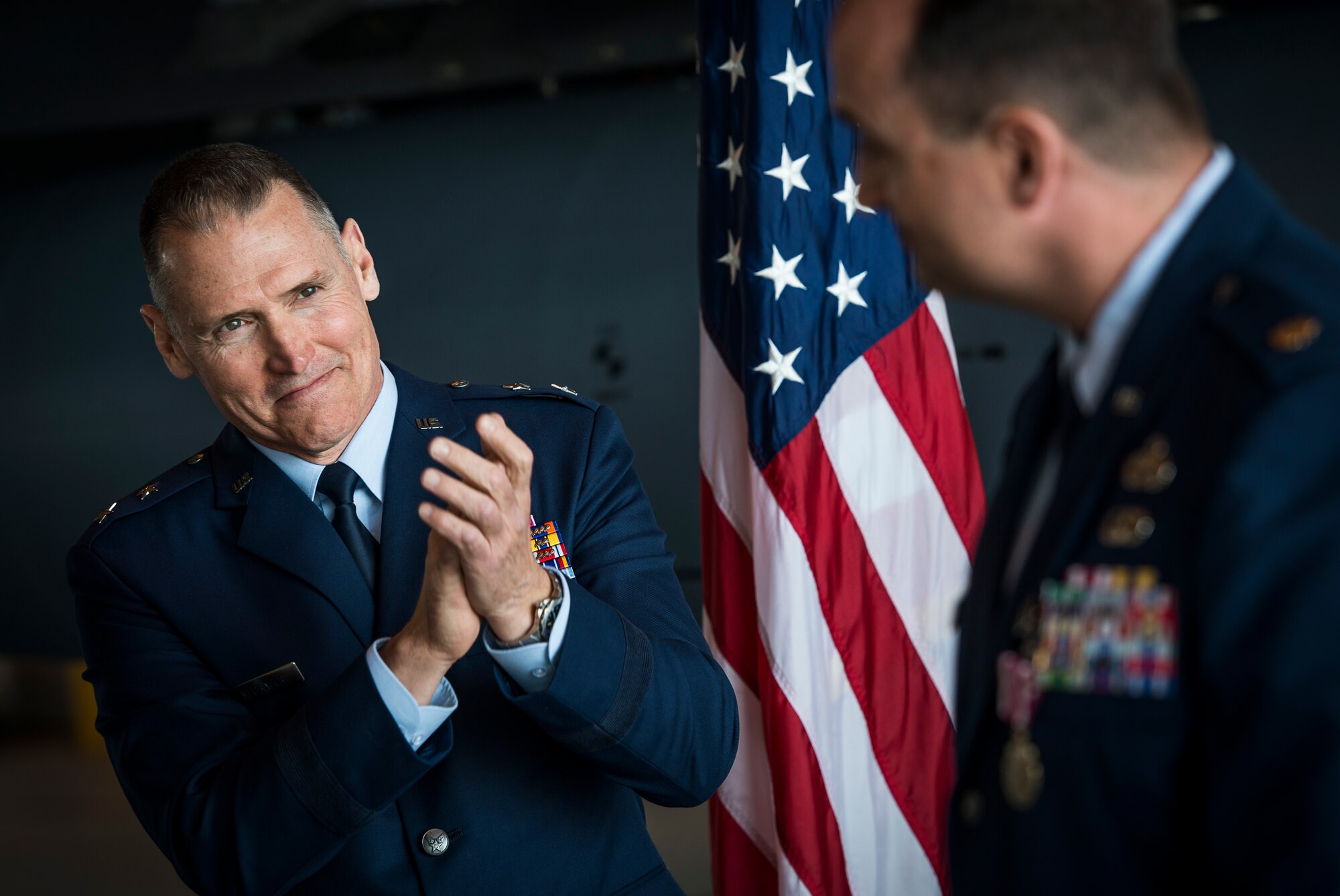 Maj. Gen. Kurt Neubauer, Air Force Chief of Safety, applauds Maj. Edward Schlegel, 366th Aircraft Maintenance Squadron, after presenting him with the meritorious service medal during Schlegel's retirement April 18, 2014, at Mountain Home Air Force Base, Idaho. Schlegel worked for Neubauer previously and asked him to officiate the ceremony. (U.S. Air Force photo by Tech. Sgt. Samuel Morse/RELEASED)