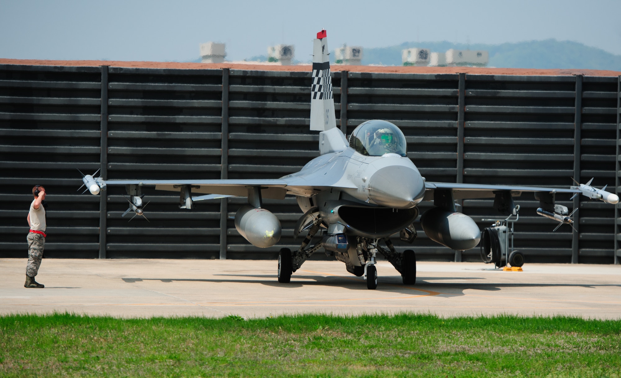 An Osan Air Base, Republic of Korea, crew chief gives his pilot a salute prior to taxing for a Max Thunder sortie during at Gwangju Air Base, ROK, April 22, 2014. The two week exercise is the Air Component-led portion of Exercise Foal Eagle and trains both ROK and U.S. Airmen bi-lateral aerial training. (U.S. Air Force photo by Senior Airman Armando A. Schwier-Morales/Released)