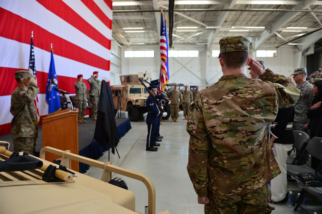 A member of the 26 Special Tactics Squadron salutes the flag during a squadron activation ceremony, April 24, 2014 at Cannon Air Force Base, N.M. The 26 STS, formerly Detachment 1 of the 720th Special Tactics Group, Hurlburt Field, Fla., is a newly activated squadron based at Cannon. (U.S. Air Force photo/ Senior Airman Eboni Reece)