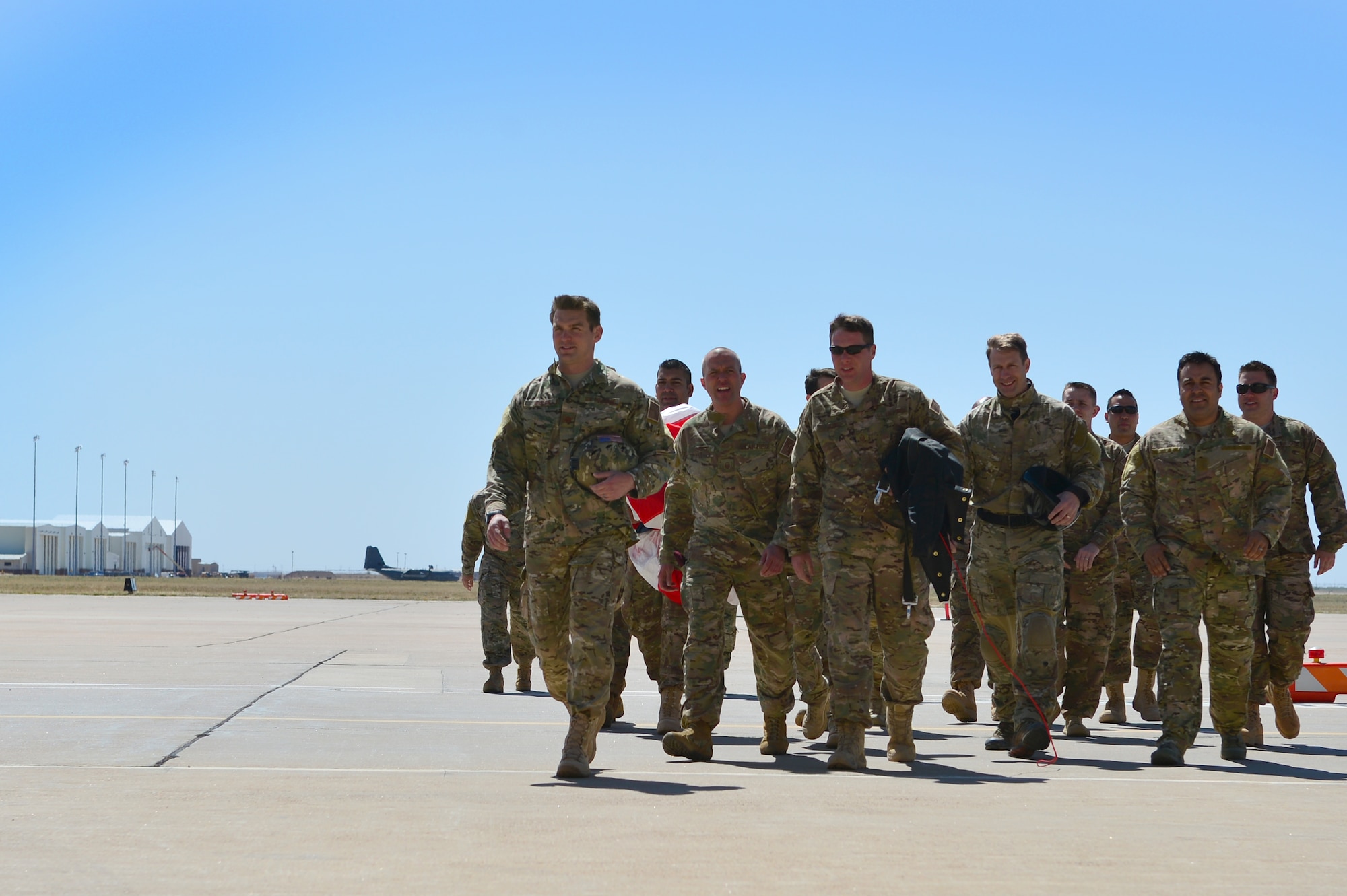 Members of the 26th Special Tactics Squadron walk across the flightline prior to a squadron activation ceremony, April 24, 2014 at Cannon Air Force Base, N.M. The 26 STS, formerly Detachment 1 of the 720th Special Tactics Group, Hurlburt Field, Fla., is a newly activated squadron based at Cannon. (U.S. Air Force photo/ Senior Airman Eboni Reece)