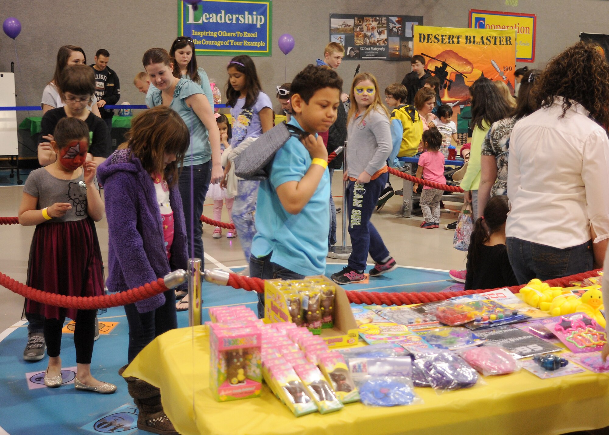Children of all ages walk in a circle on numbers for a chance to win a prize as part of a game at the Spring Carnival on April 19. Along with various games, the carnival had a raffle, food, music and a bouncy house for children. (U.S. Air Force photo/Senior Airman Cortney Paxton)