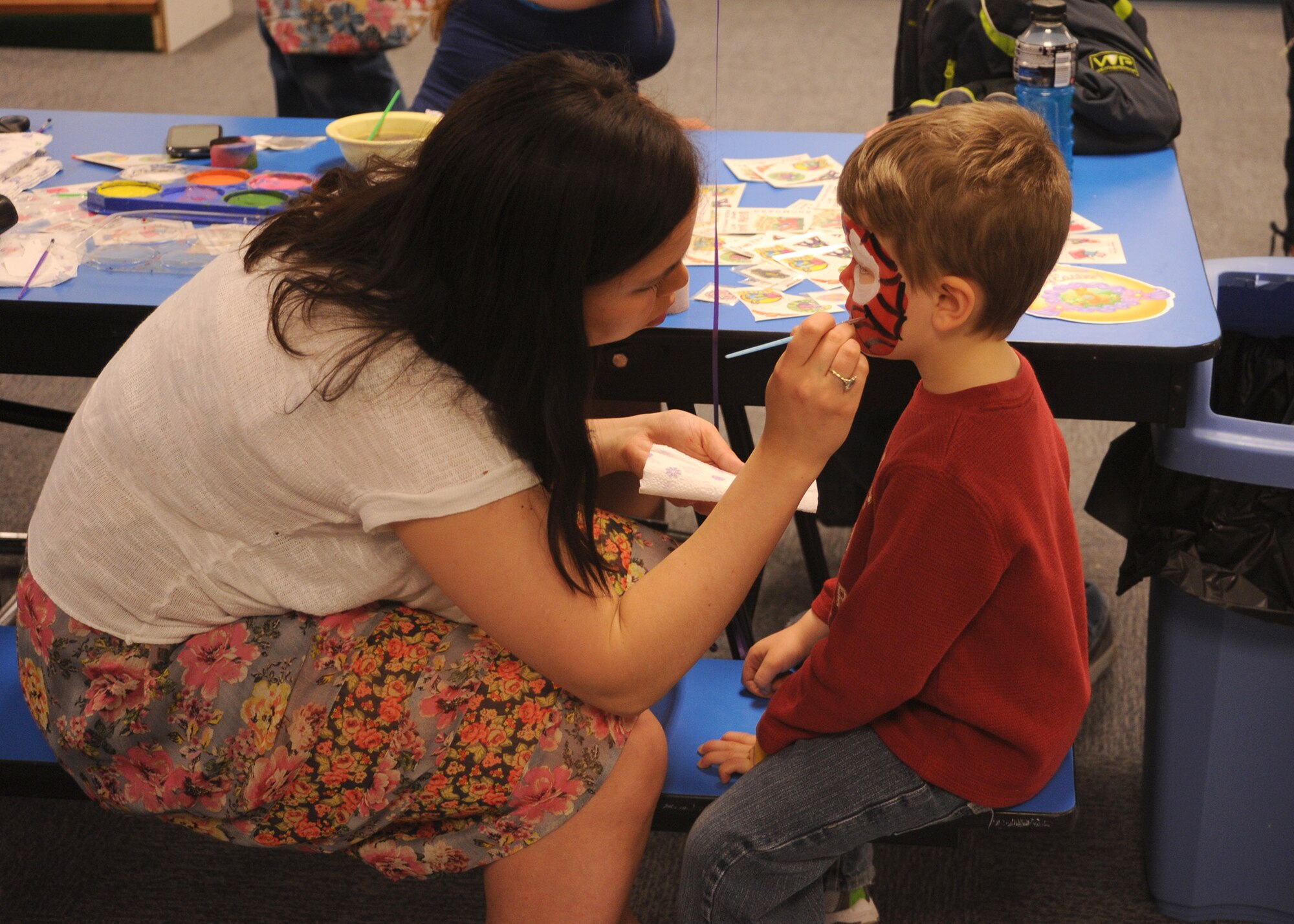 Tripp, a Malmstrom employee dependent, gets his face painted by 2nd Lt. Kim Erskine, 12th Missile Squadron member, during the Spring Carnival on April 19. Nearly 40 volunteers helped set up, run and tear down the event. (U.S. Air Force photo/Senior Airman Cortney Paxton)