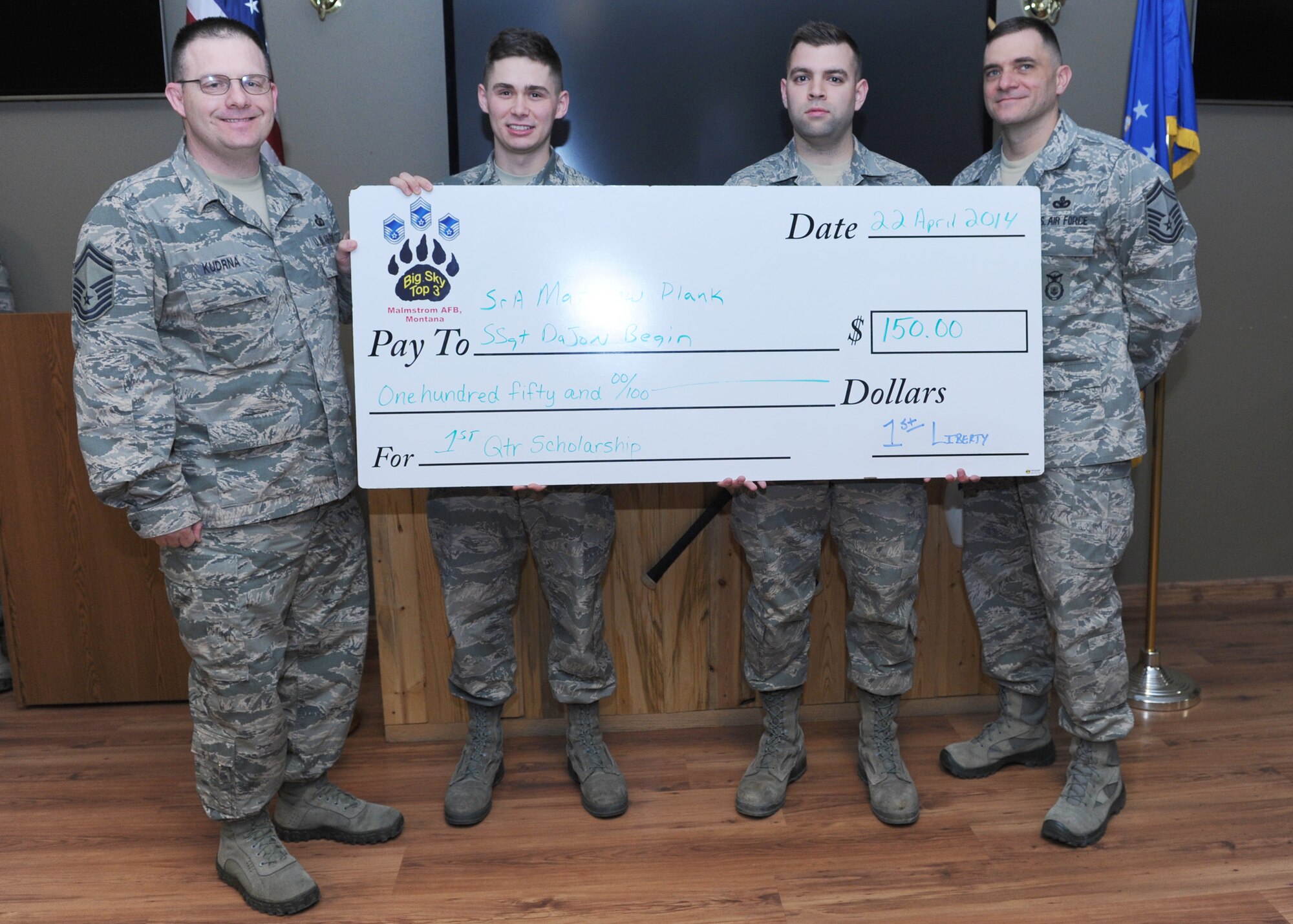 Staff Sgt. Dajon Begin (center left), 341st Force Support Squadron First Term Airmen Center NCO in charge, and Airman 1st Class Matthew Plank, 341st Missile Maintenance Squadron (center right), receive a check from Senior Master Sgts. William Kudrna, 341st Comptroller Squadron superintendent (right), and Paul Stansbury, 341st Missile Security Forces Squadron superintendent, at Aces High Bowling Center on April 22. Begin and Plank were the recipients of the Big Sky Top 3 Association first quarter scholarships for their essays regarding force management transition. The Top 3 Association offers quarterly scholarships to personnel ranked airman basic through technical sergeant. (U.S. Air Force photo/Senior Airman Katrina Heikkinen) 