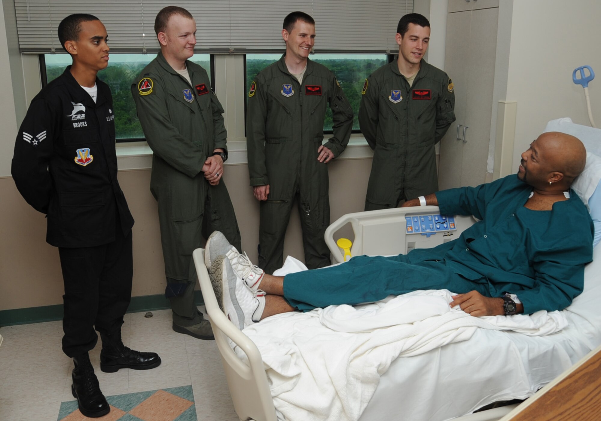 Members from the F-22 Raptor Demonstration Team and B-52H Stratofortress aircrew speak with Samuel Simpson, Navy veteran, at Overton Brooks VA Medical Center, Shreveport La., April 24, 2014. Both teams visited with patients and exchanged stories from their respective careers. The teams will be participating in the 2014 Defenders of Liberty Air Show on Barksdale Air Force Base, La., April 25-26, 2014. (U.S. Air Force photo/Staff Sgt. Sean Martin)
