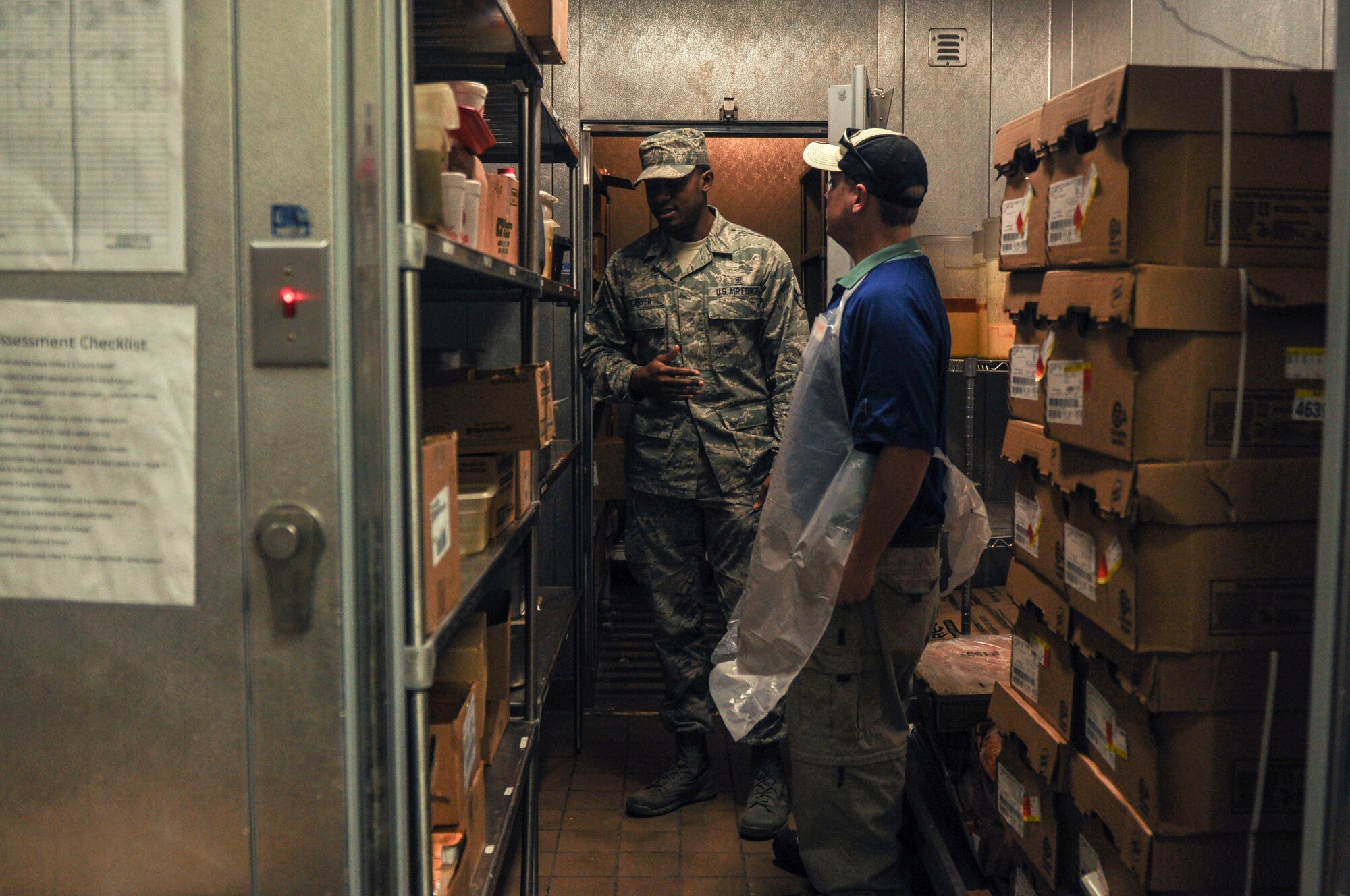 Airman 1st Class Devante Scarver, a 19th Aerospace Medicine Squadron public health technician, explains areas of improvement to a Little Rock Air Force Base facility employee during a health inspection April 15, 2014, at Little Rock AFB, Ark. Facilities receiving unsatisfactory are reevaluated within 24 hours or five days for a marginal grade instead of the usual monthly inspection. (U.S. Air Force photo by Senior Airman Regina Agoha) 