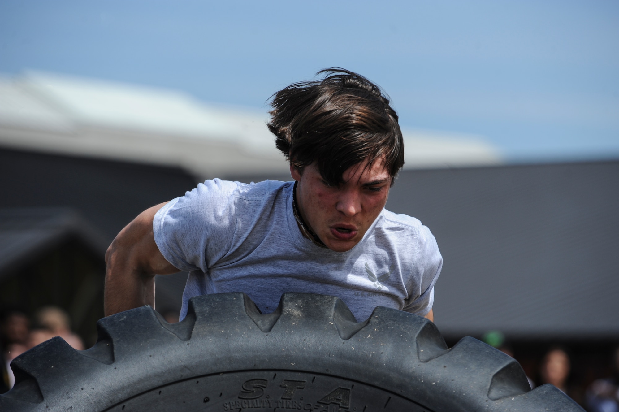 A Junior Reserve Officer Training Corps cadet flips a tire during an obstacle course held by the Health and Wellness Center’s Vital 90 class during Little Rock Air Force Base’s Junior Reserve Officer Training Corps Expo Day April 17, 2014. The annual JROTC Expo Day gives cadets an opportunity to learn and understand the Air Force’s mission and see the resources that the base provides to Airmen. (U.S. Air Force photo by Airman 1st Class Cliffton Dolezal)