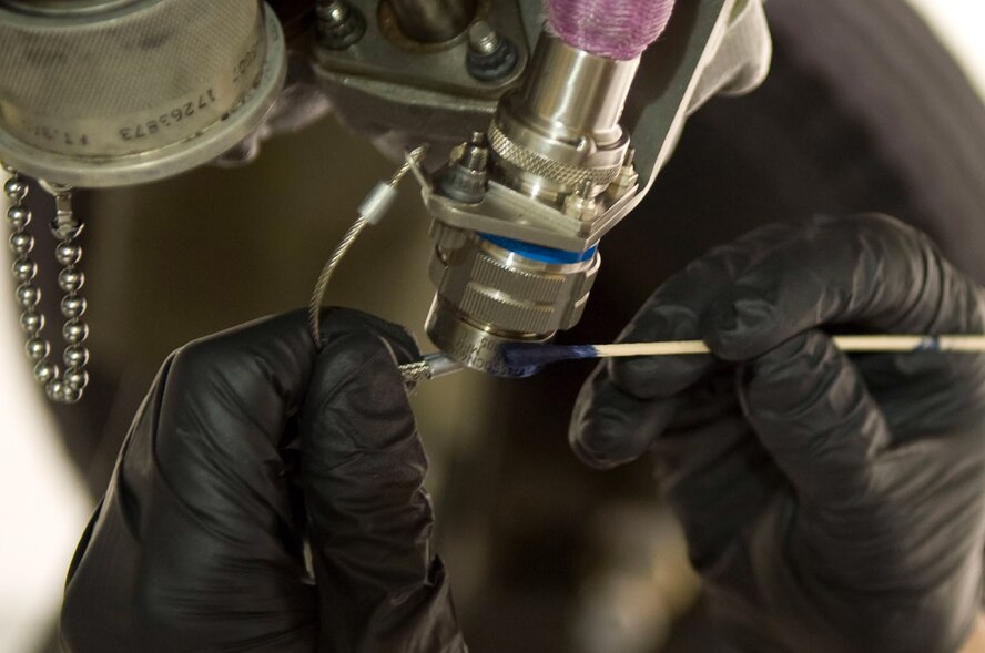 Airman 1st Class Brandan Linton, 4th Component Maintenance Squadron propulsion flight apprentice, applies blue dye to a cannon plug, April 10, 2014, at Seymour Johnson Air Force Base, N.C. The blue dye shows other maintainers the cannon plug is serviceable and ready for use. (U.S. Air Force photo/Airman 1st Class Shawna L. Keyes)   