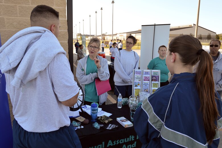 Karen Smith, Pope Field’s sexual assault response coordinator, briefs Pope Airmen about Pope’s sexual assault awareness program during Team Pope’s sexual assault awareness month 5K fun run on April 24, Pope Army Airfield, N.C. (U.S. Air Force photo/Marvin Krause)