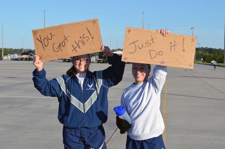 Senior Airman Chloee Franks, left, and Staff Sgt. Barbara Rankin, both from the 43rd Logistics Readiness Squadron, cheer on fellow Airmen during Team Pope’s sexual assault awareness month 5K fun run on April 24, Pope Army Airfield, N.C. (U.S. Air Force photo/Marvin Krause)