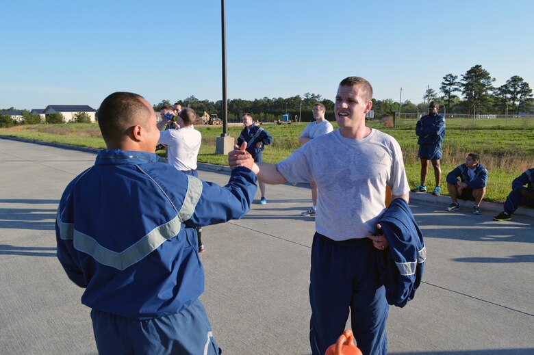 Senior Airman Norman Luquias, 43rd Force Support Squadron, left, congratulates Tech. Sgt. Jeffrey Brown, 43rd Comptroller Flight, after finishing Team Pope’s sexual assault awareness month 5K fun run on April 24, Pope Army Airfield, N.C. (U.S. Air Force photo/Marvin Krause)