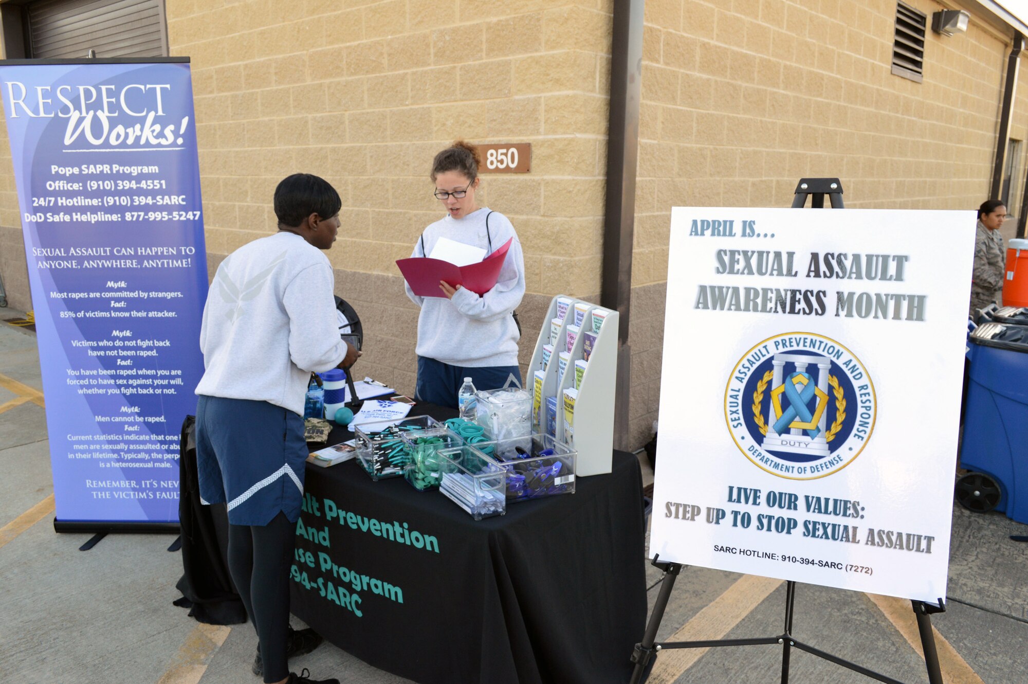 Pope Field Airmen review sexual assault prevention information during Team Pope’s sexual assault awareness month 5K fun run on April 24, Pope Army Airfield, N.C. (U.S. Air Force photo/Marvin Krause)