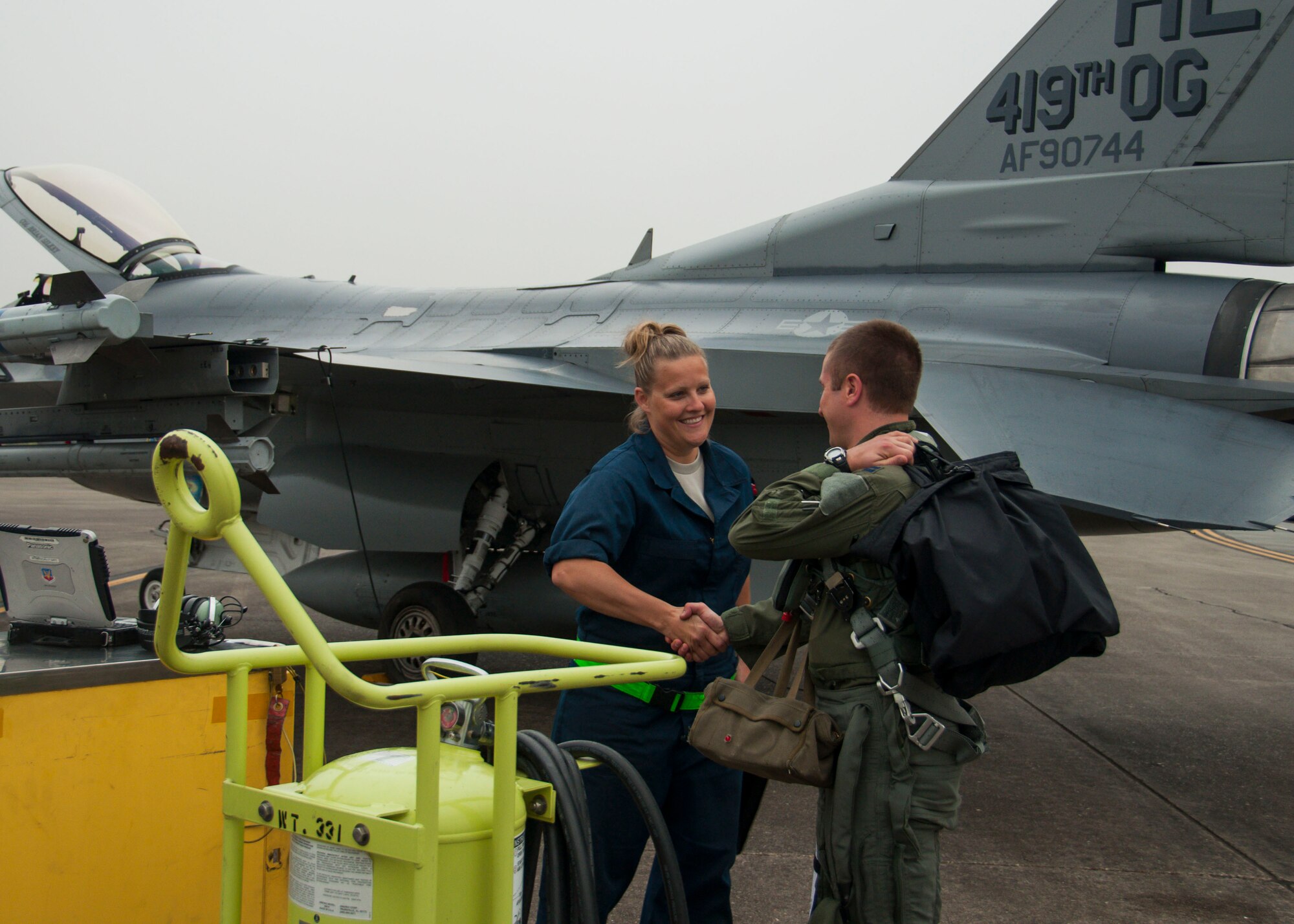 Tech Sgt. Allison Tolar, 419th Aircraft Maintenance Squadron crew chief, greets Capt. Mike Casey, 466th Fighter Squadron pilot, as he arrives for his training flight today. Casey and other pilots from Hill Air Force Base were able to fly their F-16s side-by-side with the F-35 Lightning II for the first time today.  The 419th Fighter Wing is currently on their annual training at  Eglin Air Force Base, Fla. (U.S. Air Force photo/Senior Airman Crystal Charriere)