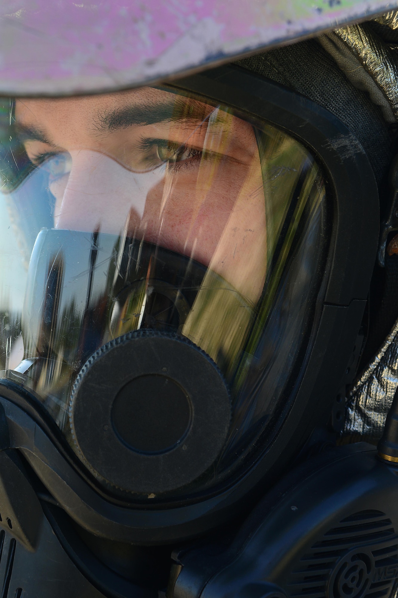 U.S. Air Force Staff Sgt. Chad Green Beshear, 633rd Civil Engineer Squadron Fire Department firefighter, dons fire protective gear during a simulated aircraft fire at Langley Air Force Base, Va., April 23, 2014. Airmen from the 633rd CES shared best practices with a Royal Netherlands Air Force counterpart to foster relationships and increase capabilities. (U.S. Air Force photo by Staff Sgt. Antoinette Gibson/Released)
