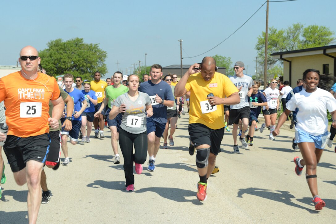 U.S. Service members from the Air National Guard, Air Force Reserves, Army, Navy and Marines along with their families participate in the Sexual Assault Prevention Response 5K fun-run at Naval Air Station Fort Worth Joint Reserve Base, Texas, April 18, 2014 in observance of the SAPR Month awareness campaign. (U.S. Air National Guard photo by Senior Master Sgt. Elizabeth Gilbert/Released)