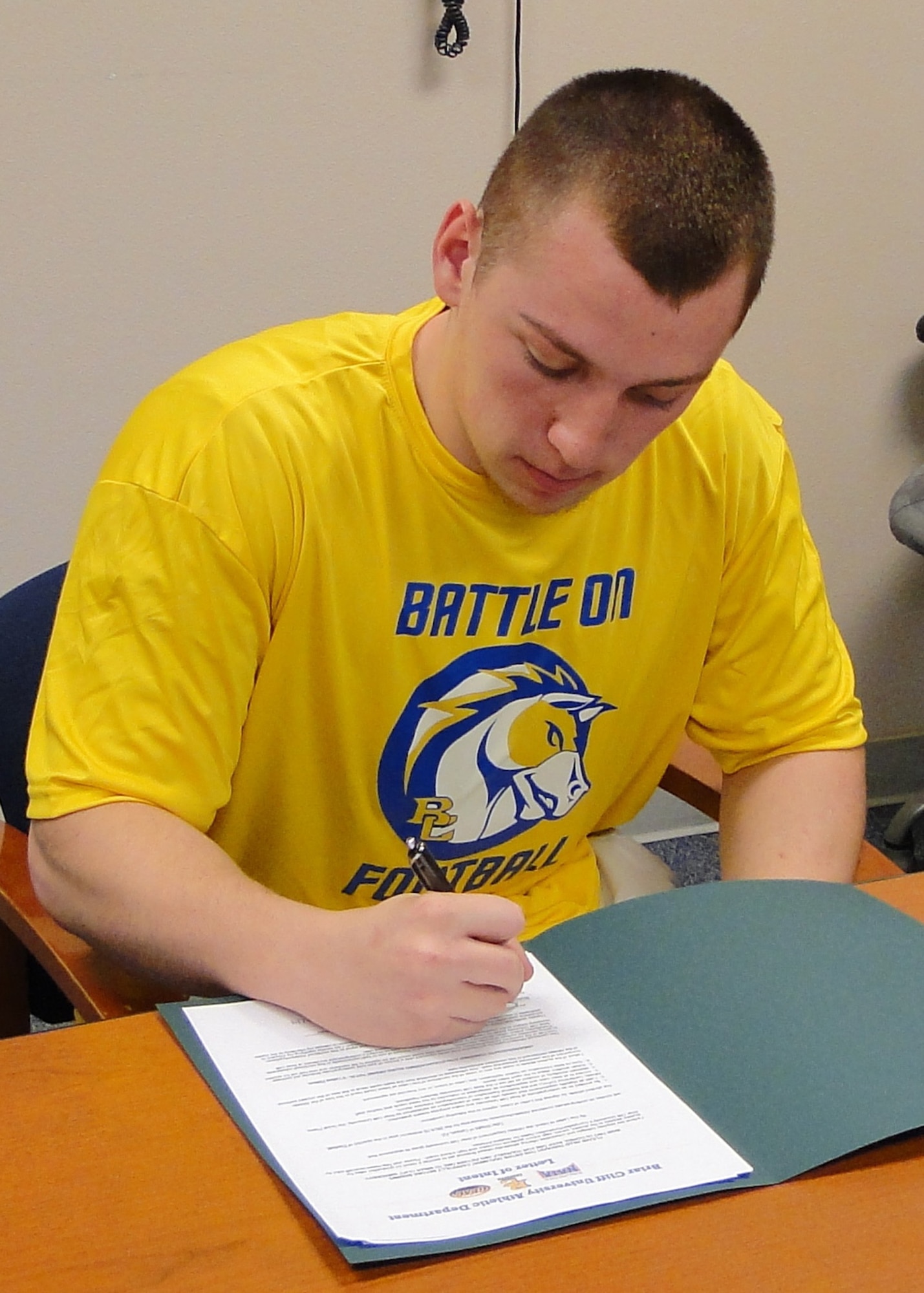 Tyler Wright, Cienega High School Bobcats defensive tackle, signs a letter of intent to play football at Briar Cliff University, located in Sioux City, Iowa. Tyler, son of Maj. Shannen M. Wright, 355th Medical Operations Squadron, suffered a torn anterior cruciate ligament in his right knee and was treated by the 355th Medical Group at Davis-Monthan Air Force Base, Ariz.(Courtesy Photo)