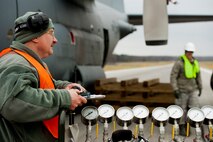 U.S. Air Force Reserve Chief Master Sgt. Paul Wagner, aerospace maintenance superintendant with the 910th Maintenance Squadron, and a Wing Inspection Team (WIT) member, watches Airmen on the Crash, Damaged, Disabled, Aircraft Recovery (CDDAR) team build a dunnage system under a C-130 aircraft wing during a Major Accident Readiness Exercise (MARE) here, April 23.  The dunning system supports large airbags that can be inflated to lift the aircraft. In the exercise scenario, the C-130 aircraft’s landing gear collapsed while landing on the assault strip. Debris from the aircraft hit a private aircraft taxiing nearby. Base emergency response personnel tested their response capability while Wing Inspection Team (WIT) members observed. U.S. Air Force photo/Eric M. White.