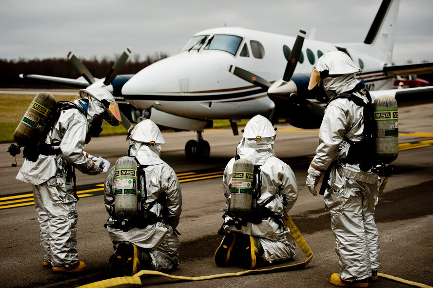 910th Airlift Wing firefighters simulate an emergency response during a Major Accident Readiness Exercise (MARE) here, April 23, 2014. In the exercise scenario, a C-130 aircraft’s landing gear collapsed while landing on the assault strip. Debris from the aircraft hit a private aircraft taxiing nearby. Base emergency response personnel tested their response capability while Wing Inspection Team (WIT) members observed. U.S. Air Force photo/Eric M. White.