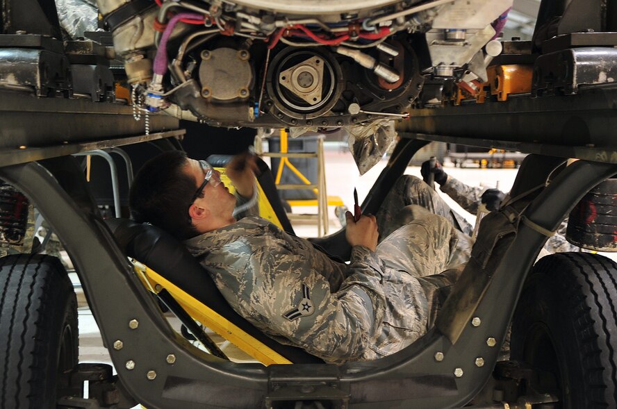 Airman 1st Class Anthony Kelsey, 4th Component Maintenance Squadron propulsion flight apprentice, inspects the underside of an F-15E Strike Eagle engine, April 10, 2014, at Seymour Johnson Air Force Base, N.C. The propulsion flight maintains more than 200 jet engines assigned to the 4th Fighter Wing. (U.S. Air Force photo/Airman 1st Class Shawna L. Keyes) 