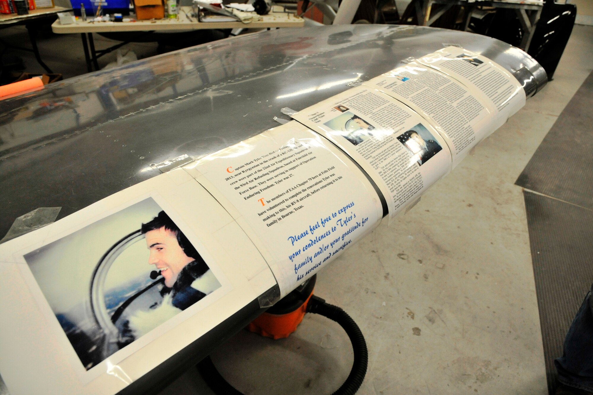 Laminated papers describing the life of fallen Airman, Capt. Tyler Voss, are taped to the wing of an RV-8 aircraft being rebuilt by Staff Sgt. Matthew Perroux in Voss’s memory at a maintenance hangar at Felts Field in Spokane, Wash., Feb. 22, 2014. Perroux is a 373rd detachment aircraft maintenance instructor and Voss was a 93rd Air Refueling Squadron crew member who lost his life in a tragic KC-135 Stratotanker crash May 3, 2013, near Chon-Aryk, Kyrgyzstan. (U.S. Air Force photo by Senior Airman Mary O’Dell/Released)