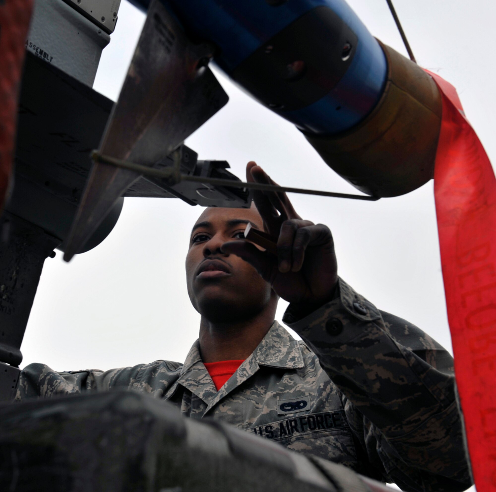 Airman 1st Class Deangelo Hamilton, 90th Aircraft Maintenance Unit weapons load crew member, checks an AIM-9 Sidewinder missile during a quarterly 3rd Maintenance Group load crew competition on Joint Base Elmendorf-Richardson, Alaska, April 18, 2014. The mission of the load crew is to load munitions onto aircraft safely, efficiently and reliably. (U.S. Air Force photo/Airman 1st Class Tammie Ramsouer)